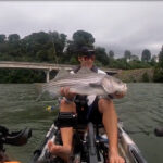 Guided By Osprey, Angler Stumbles Upon Pre-Storm Feeding Frenzy (Video) Micheal Kaal, angler, holds up a striped bass catch