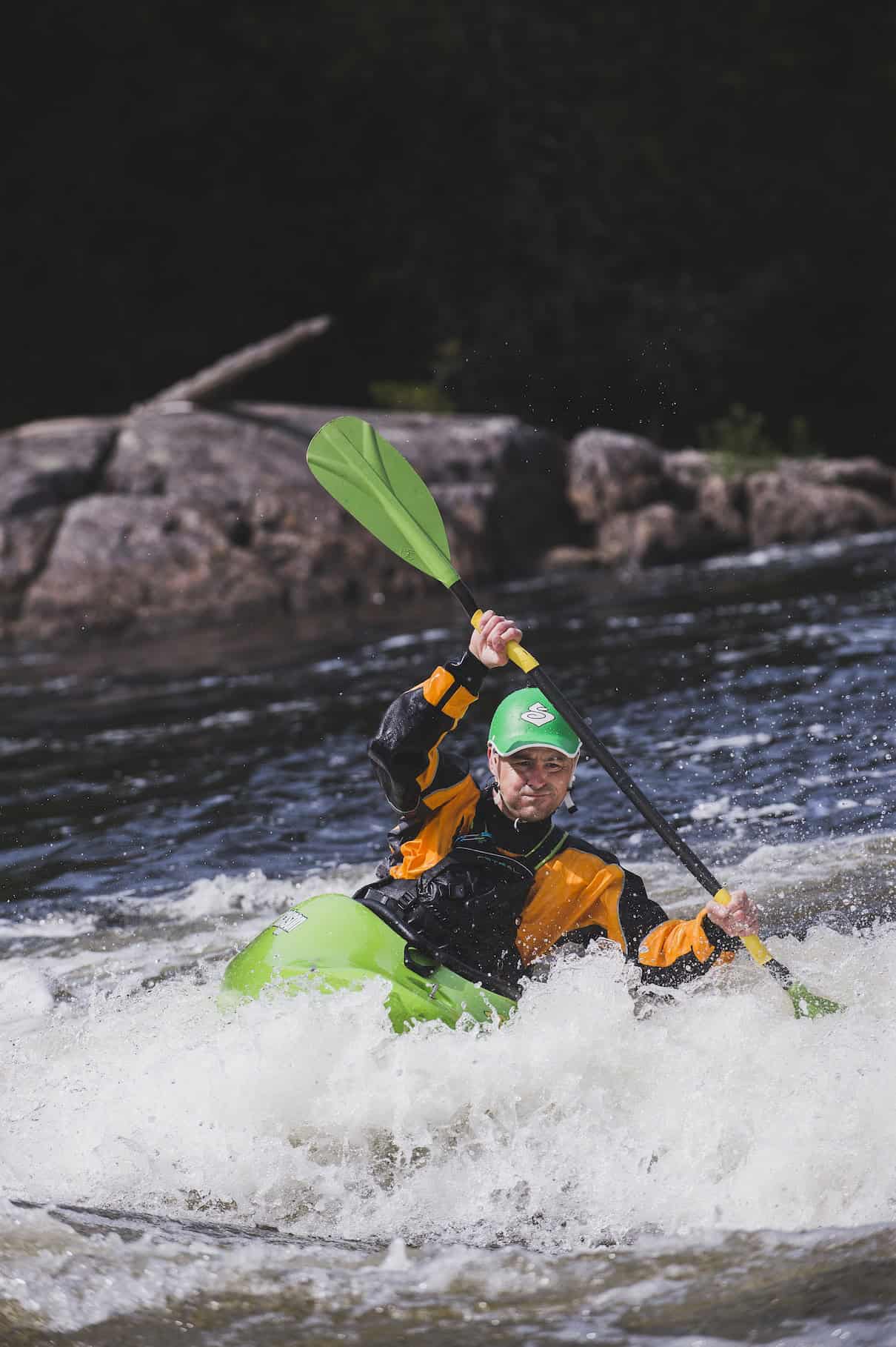 Person whitewater kayaking in rapids
