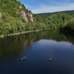 Kayak Adventure Series: New River Revival Recap Two fishing kayaks on lake surrounded by cliffs