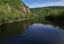 Kayak Adventure Series: New River Revival Recap Two fishing kayaks on lake surrounded by cliffs