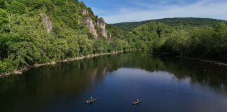 Kayak Adventure Series: New River Revival Recap Two fishing kayaks on lake surrounded by cliffs