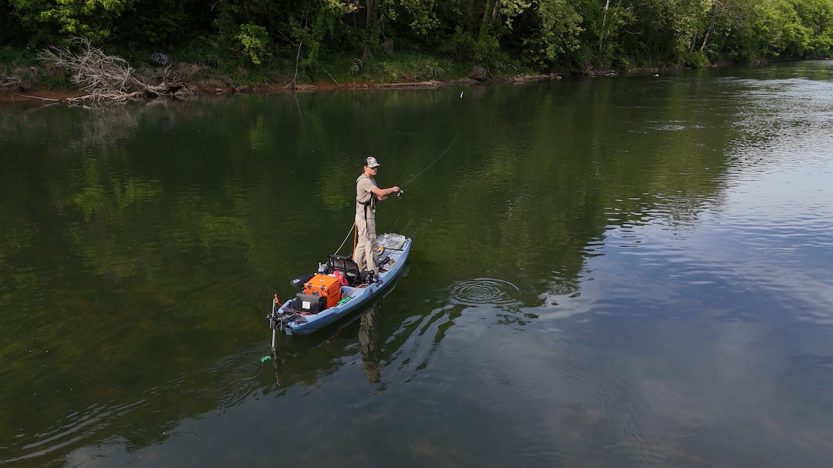 Angler fishing while standing on kayak