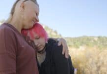 River Mamma Woman hugging her teenage child