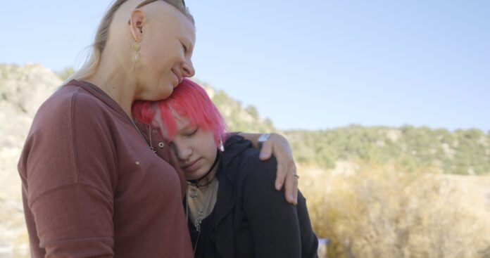 Woman hugging her teenage child