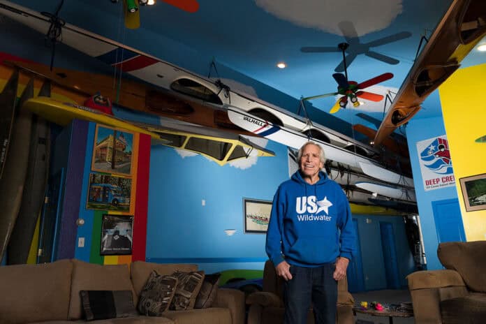 charles-albright-boat-house-0-scott-sady-c Charles Albright stands in the living room of his Boat House, housing his extensive collection of kayaks
