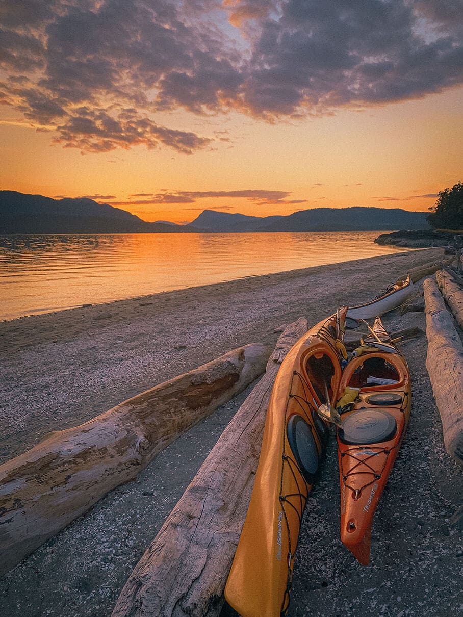 kayaks at sunset on the beach