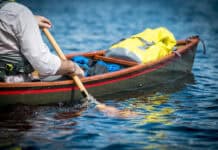 man paddles a tripping canoe using the goon stroke