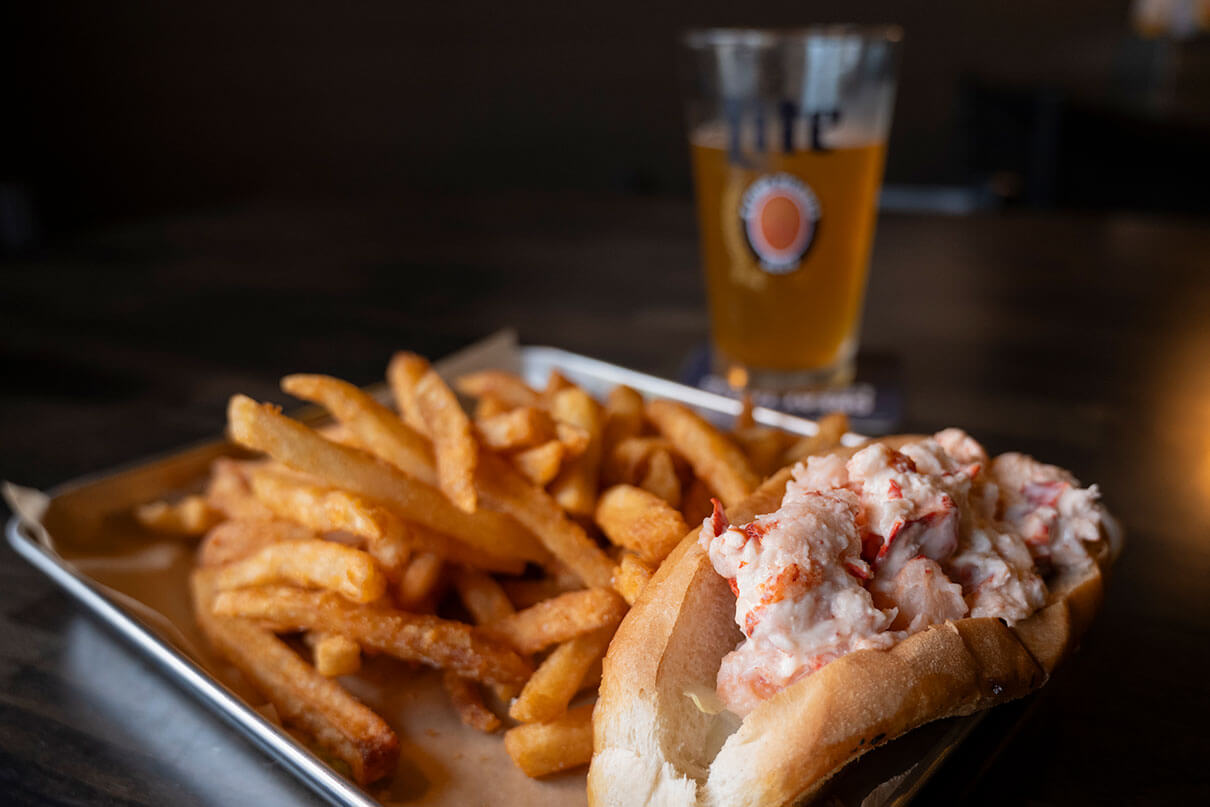lobster roll, fries and pint of beer at a Maine restaurant