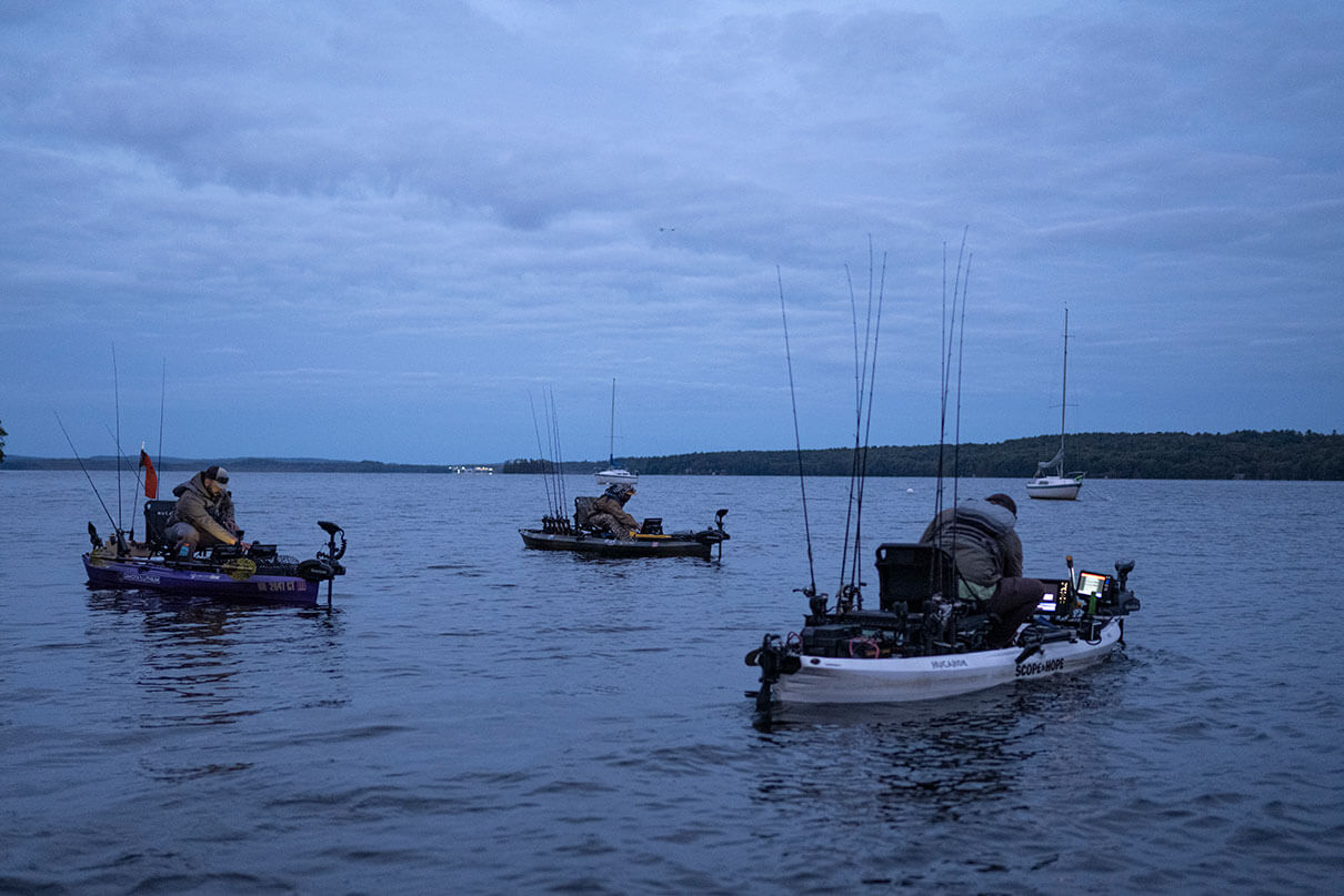 kayak anglers fish at dawn on tournament day on Messalonskee Lake