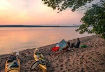 Join Our Upcoming Webinar: How to Get Your Dream Girls’ Paddling Trip Out Of The Group Chat women sit on camp chairs at sunset at a campsite during their girls paddling trip