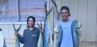 Tiger Shark Attacks Couple on Fishing Kayak in Hawaii Man and woman standing in front of house holding fish