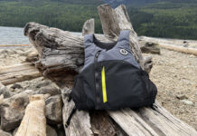 Kayak Anglers Have A New PFD Option—Here’s What You Need To Know Level 50 PFD from Mustang Survival lying on logs near water.