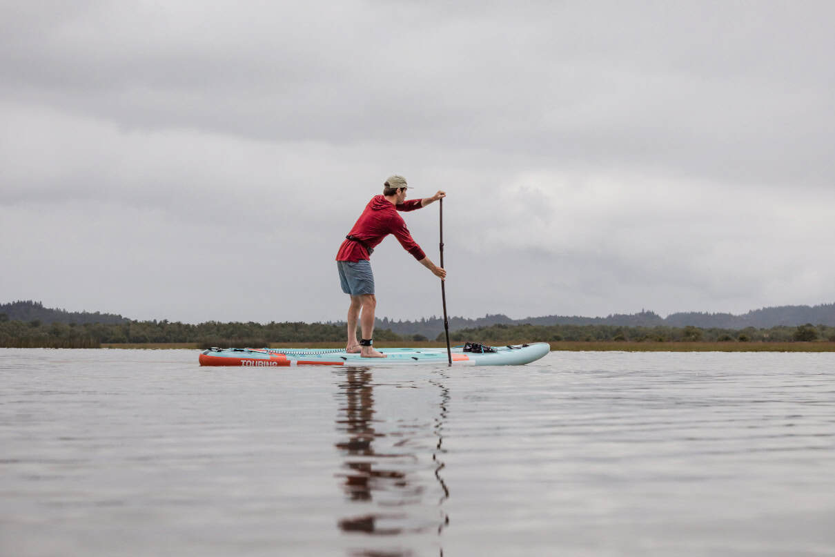Niphean Pro Touring 12 foot long inflatable standup paddleboard on lake.