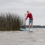 Cover More Water With This Budget-Friendly Inflatable Touring Paddleboard Niphean Pro Touring 12 foot long inflatable standup paddleboard on lake.