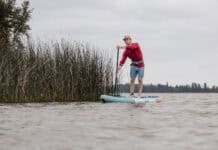 Cover More Water With This Budget-Friendly Inflatable Touring Paddleboard Niphean Pro Touring 12 foot long inflatable standup paddleboard on lake.