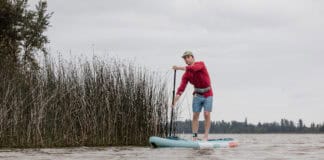 Cover More Water With This Budget-Friendly Inflatable Touring Paddleboard Niphean Pro Touring 12 foot long inflatable standup paddleboard on lake.