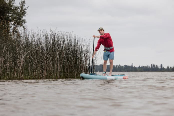 Niphean Pro Touring 12 foot long inflatable standup paddleboard on lake.