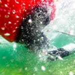 Myth Of The Bombproof Roll underwater photo of a sea kayaker mid-roll