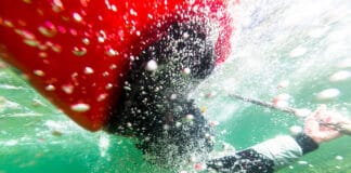 Myth Of The Bombproof Roll underwater photo of a sea kayaker mid-roll