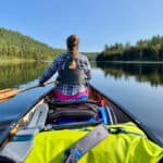 Best Prime Day Deals For Paddlers photo of woman paddling a laden canoe from the stern