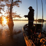 Next-Level Fishing: Hit The Road man stands and fishes from kayak at dawn
