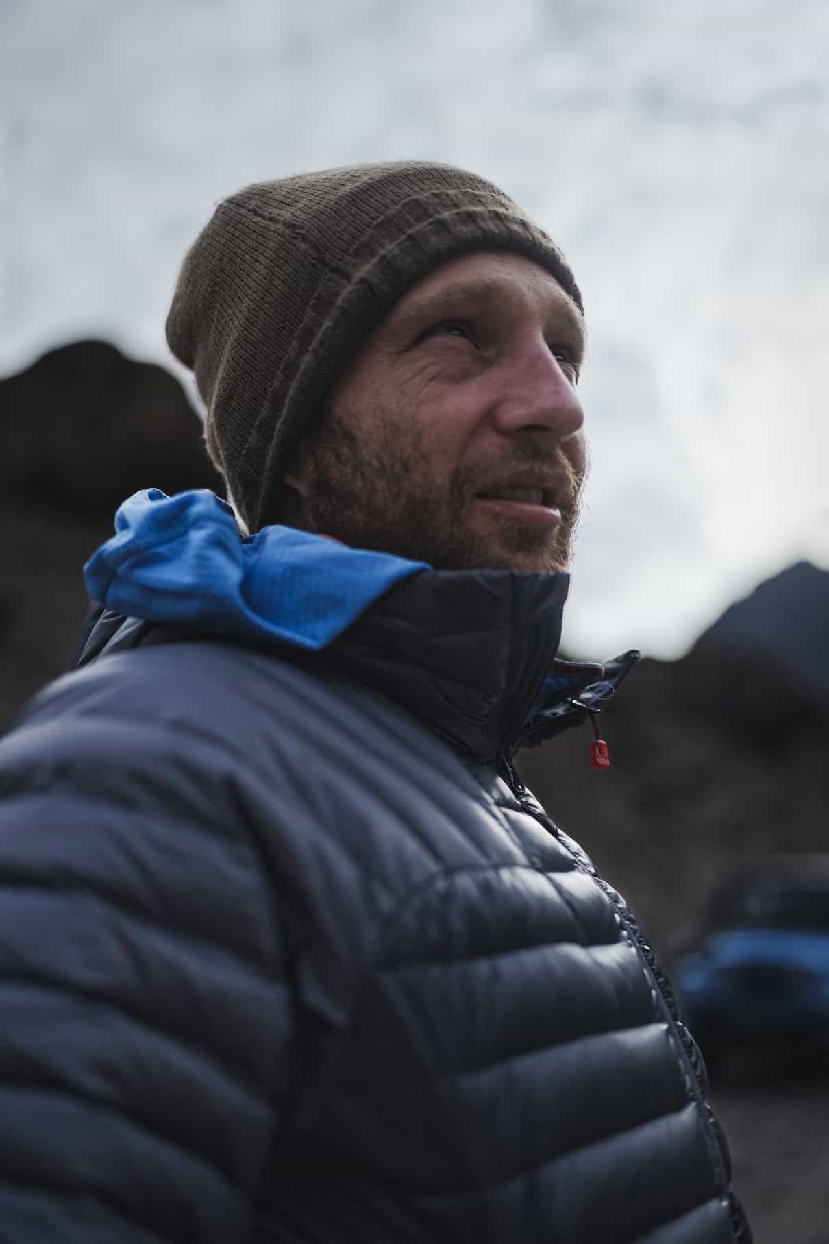 Man wearing puffy jacket and winter hat