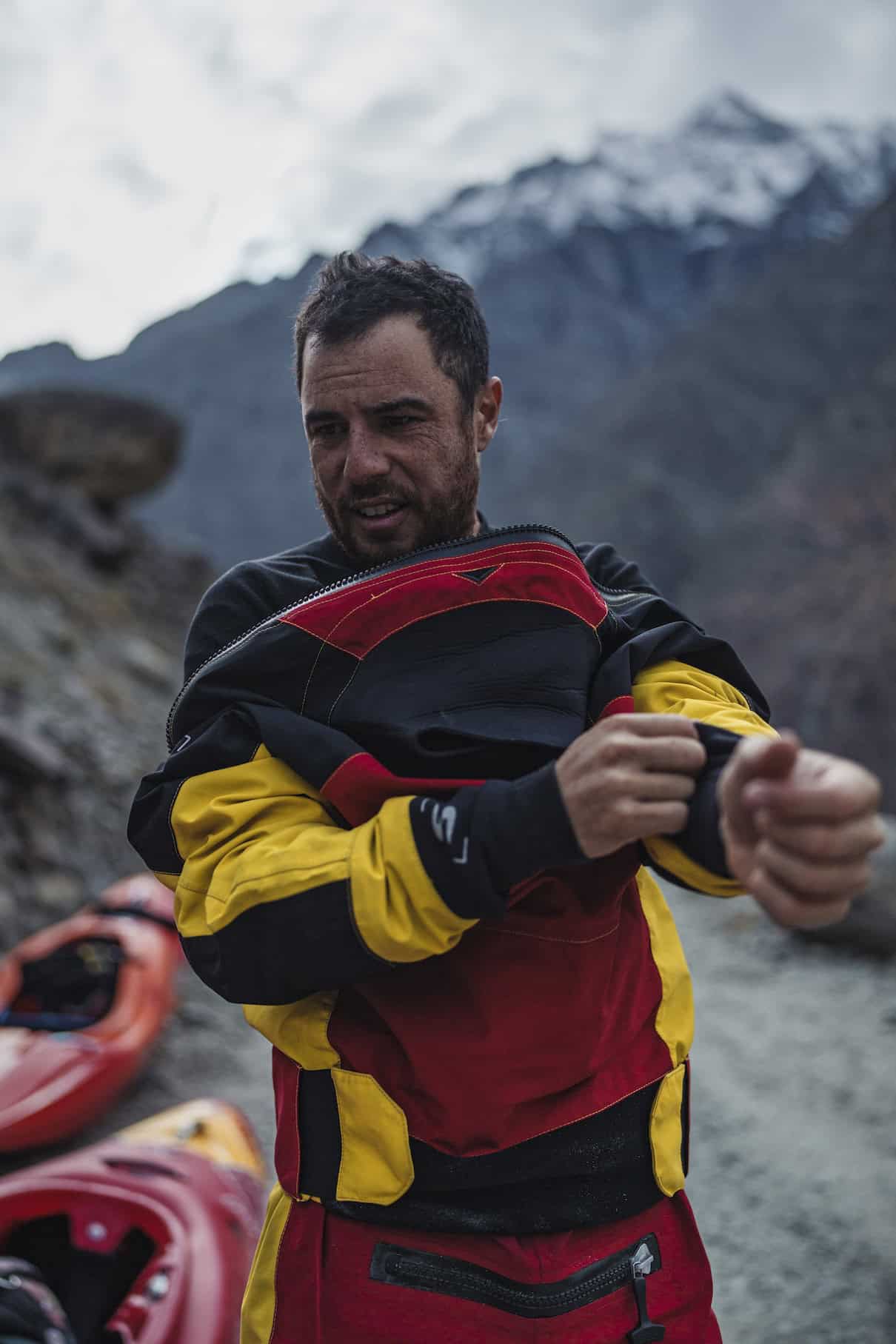 Man putting drysuit on