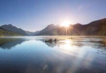 These 6 Montana Lakes Belong On Every Paddler’s Bucket List kayaking at sunrise
