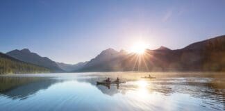 These 6 Montana Lakes Belong On Every Paddler’s Bucket List kayaking at sunrise