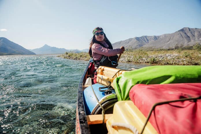 Bobbi Rose Koe paddles a packed canoe in Canada's North