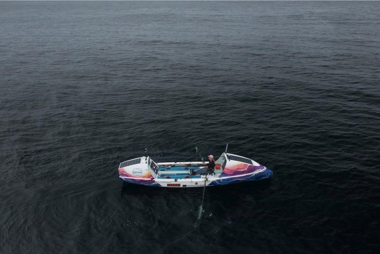 woman rowing boat in ocean