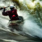 Pro Paddlers On The Scariest Thing That Ever Happened To Them long exposure photo of a man whitewater kayaking in breaking rapids