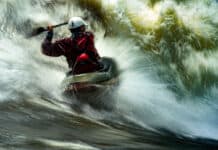 Pro Paddlers On The Scariest Thing That Ever Happened To Them long exposure photo of a man whitewater kayaking in breaking rapids