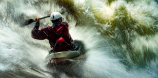Pro Paddlers On The Scariest Thing That Ever Happened To Them long exposure photo of a man whitewater kayaking in breaking rapids