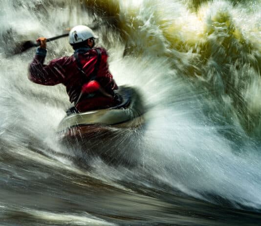 Pro Paddlers On The Scariest Thing That Ever Happened To Them long exposure photo of a man whitewater kayaking in breaking rapids