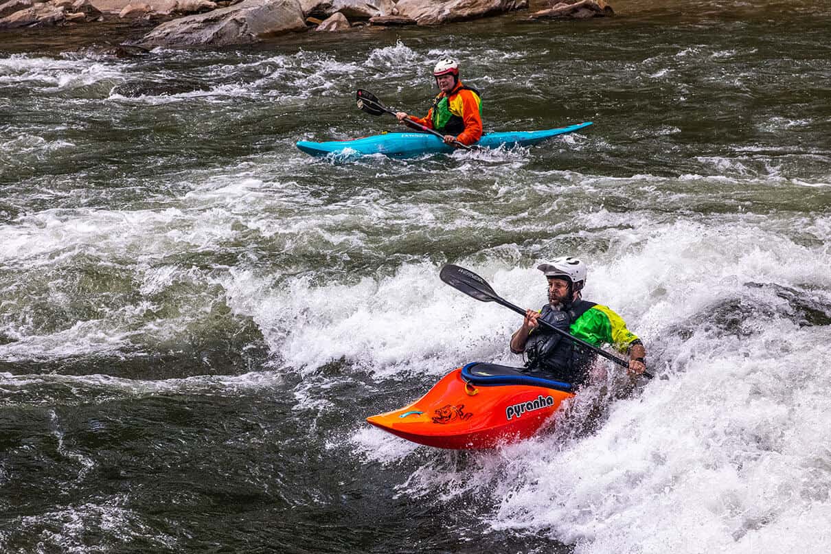 two men kayak on the Nolichucky River