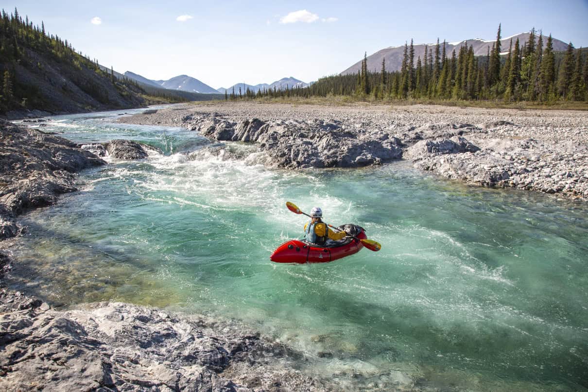 A paddler at the bottom of a rapid.