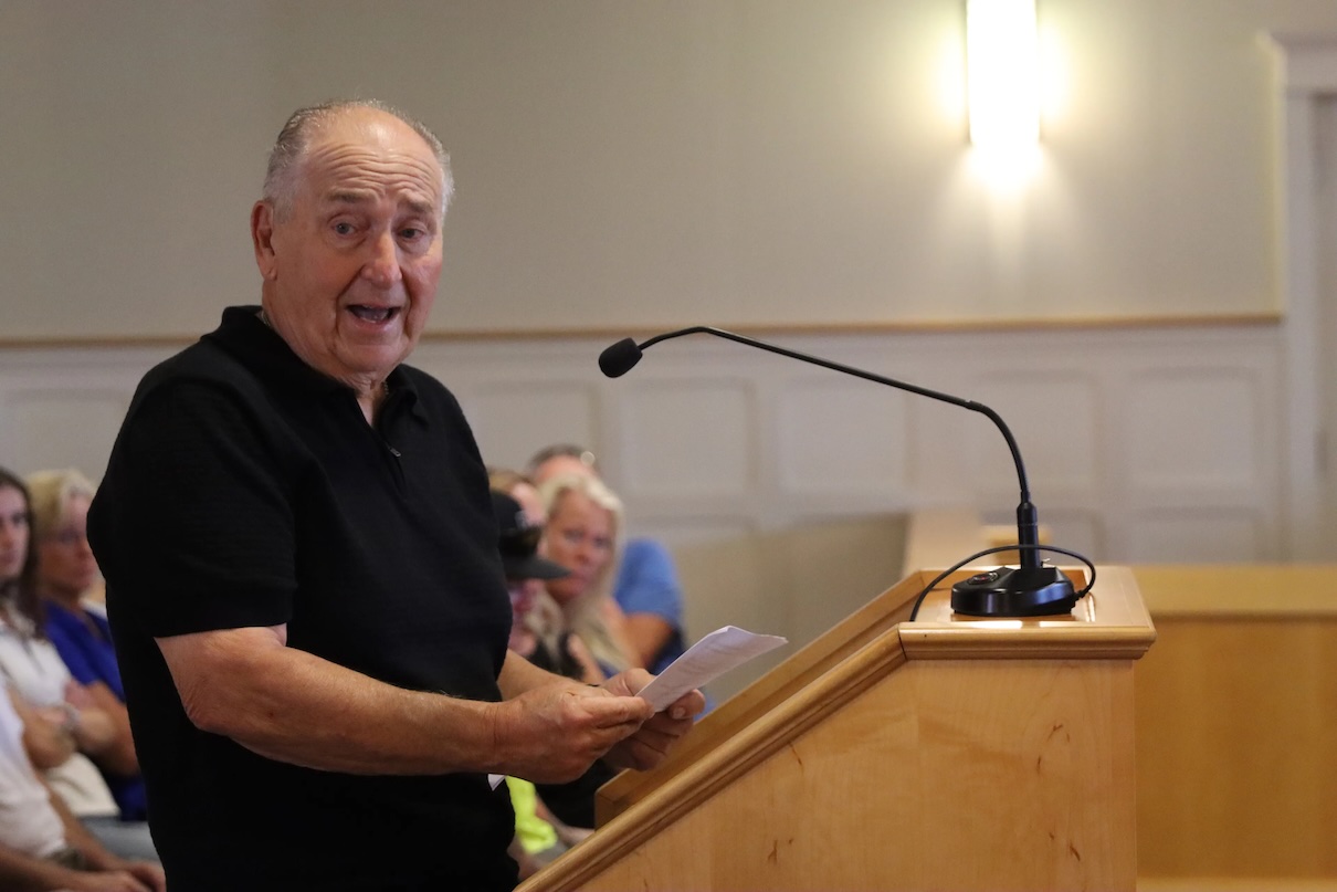 man speaking at podium