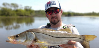 Bart Swab holds up a large snook he caught by kayak