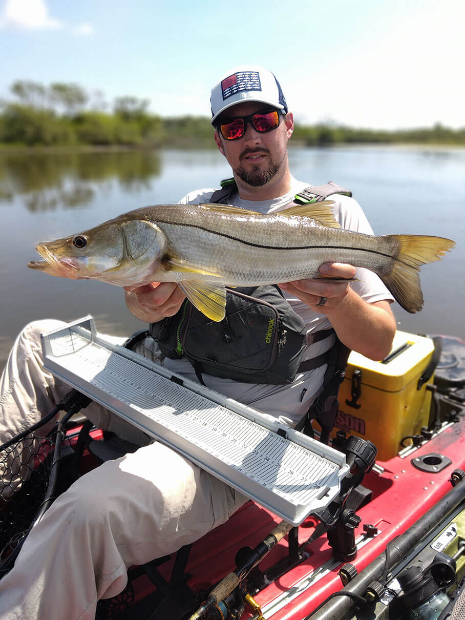Bart Swab holds up a large snook he caught by kayak