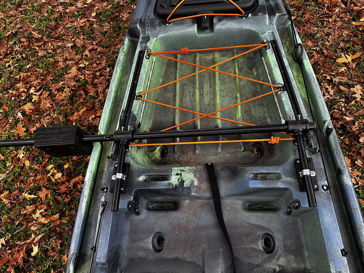 DIY outrigger bar setup affixed across the kayak deck