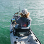 Gear Of The Year: Best Stuff For Offshore Fishing person offshore kayak fishing with gear including Lowrance fish finder