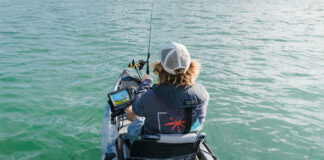 Gear Of The Year: Best Stuff For Offshore Fishing person offshore kayak fishing with gear including Lowrance fish finder