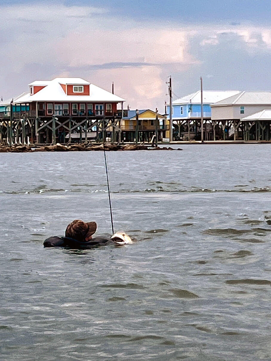Travis Puls Jr. holds onto his redfish after capsizing during the tournament