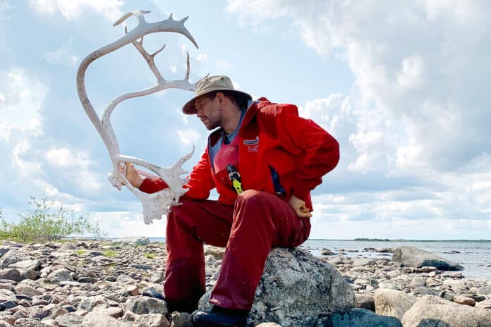 Stephan Kesting poses with caribou antlers during his solo expedition in the Barren Lands