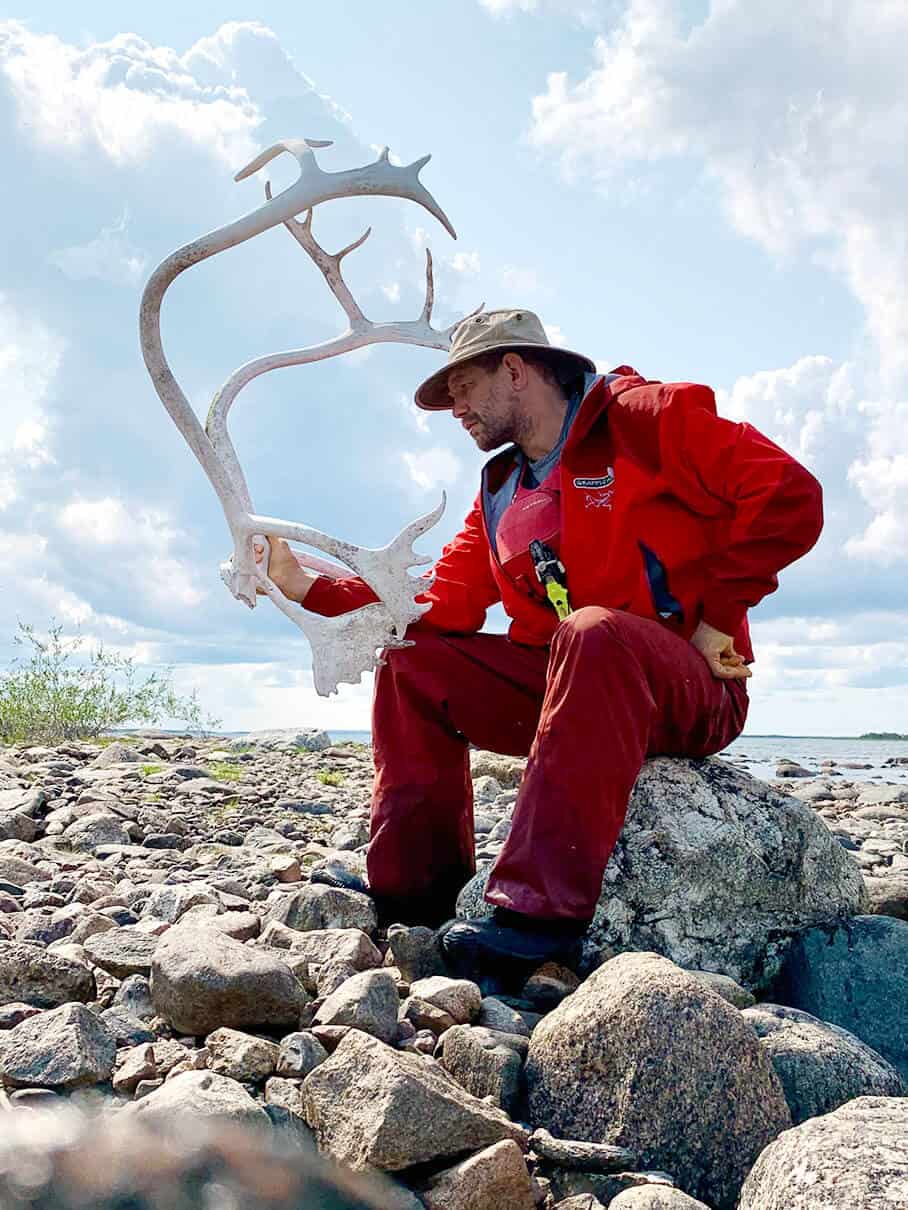 Stephan Kesting poses with caribou antlers during his solo expedition in the Barren Lands
