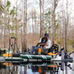 Best New Fishing Gear For SUP Fishing man fishes from a rigged up Sea Eagle FS1210 inflatable paddleboard
