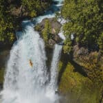 Is Making Whitewater More Accessible Killing Its Appeal? whitewater kayaker drops a large waterfall