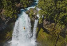 Is Making Whitewater More Accessible Killing Its Appeal? whitewater kayaker drops a large waterfall