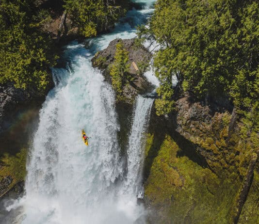 Is Making Whitewater More Accessible Killing Its Appeal? whitewater kayaker drops a large waterfall